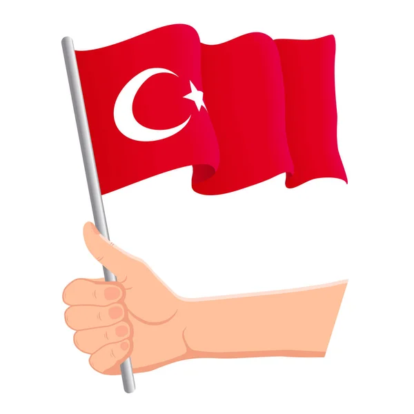 Mano sosteniendo y agitando la bandera nacional de Turquía. Aficionados, día de la independencia, concepto patriótico. Ilustración vectorial — Vector de stock