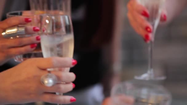 アルコールのグラスとウイスキーのグラスを持つ人々 は、テーブルで祝います。人々 は、グラス シャンパン、ウイスキーをチャリンという音します。 — ストック動画
