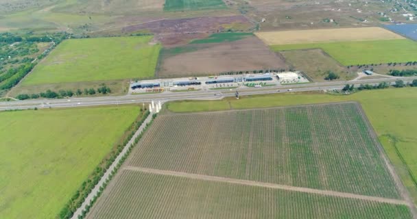 Vista panorámica desde el aire hasta campos agrícolas y autopistas. El negocio agrario — Vídeos de Stock