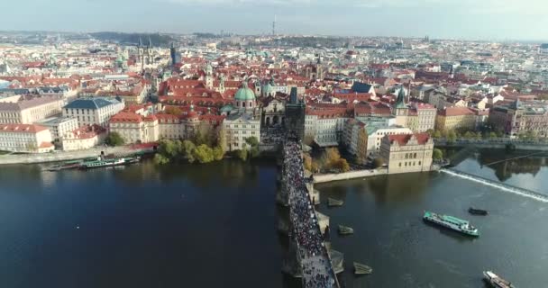 Panoramisch uitzicht van bovenaf naar het centrum van Praag en de Karelsbrug, toeristen op de Karelsbrug, Moldau, vlucht over de Karelsbrug — Stockvideo