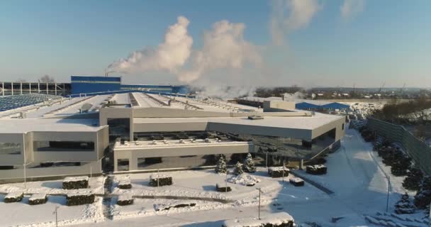 A modern factory or commercial building, the exterior of a modern factory or plant, building facade and car parking, panoramic view from the air, winter time, sunny day, blue sky — Stock Video