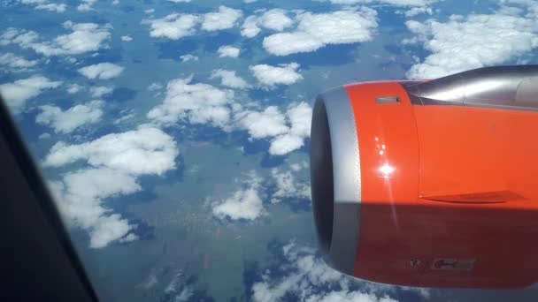 Beautiful view from the airplane window to the blue sky and white clouds, white clouds float above the ground — Stock Video
