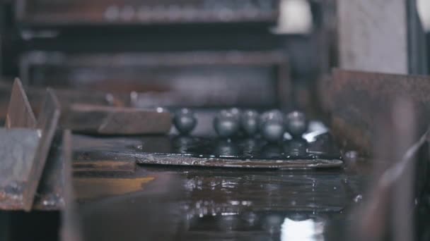 Production of balls for a ball mill, production of bearings A group of steel balls is rolling — Stock Video