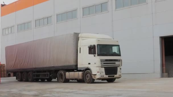 The movement of a white truck on the road, White semi-truck rides through the factory