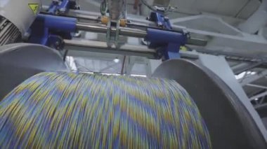 Kablo fabrikası. Yapım aşamasında elektrik kablosunun bobbin kutusuna sarılması. Kablo Pdrodüksiyonu