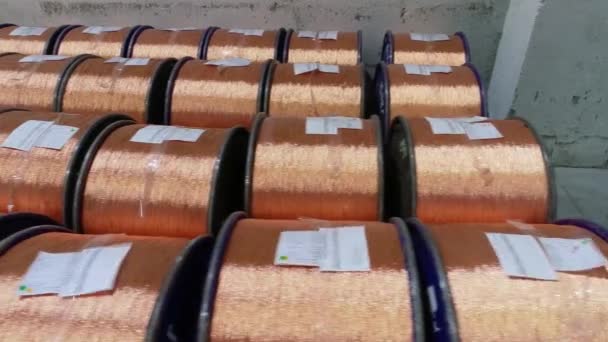 Copper wires with spools, span over coils with copper wire. Coil warehouse with copper wire — Stock Video