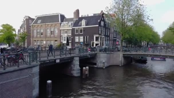 Panorama of Amsterdam street. Ordinary life in Amsterdam, the beautiful streets of Amsterdam, many bicycles in Amsterdam — Stock Video