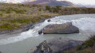 Patagonya 'da şelale, Şili' de şelale, Patagonya 'da şelale, arka planda dağlar..