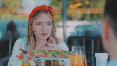 Kız pizzacıdaki bir adamla iletişim kuruyor. Pizzacıda randevusu olan bir kız. Güzel kız bir erkekle iletişim kurar.