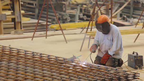 Construcción del marco de acero. Un soldador suelda una estructura metálica. Soldador de construcción. Construcción de metal de soldadura. — Vídeos de Stock