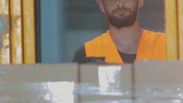 Arbeiter in einem modernen Lager. Der Arbeiter geht ins Lager der Fabrik. — Stockvideo