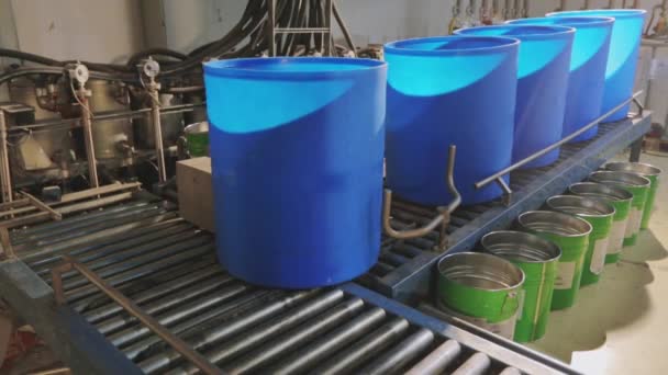 Barriles azules en una línea automatizada en una fábrica. El proceso de coloración en la fábrica — Vídeos de Stock