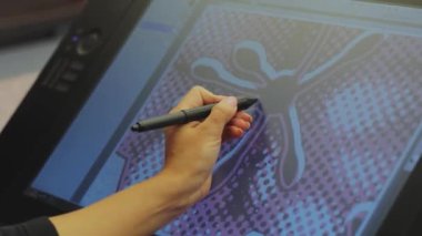 Tasarımcı bir grafik tableti çizer. Etkileşimli kalem ekranıyla çalışıyor. Grafik tableti çiziyorum. Yakın plan. Duvar kağıdı üretimi.