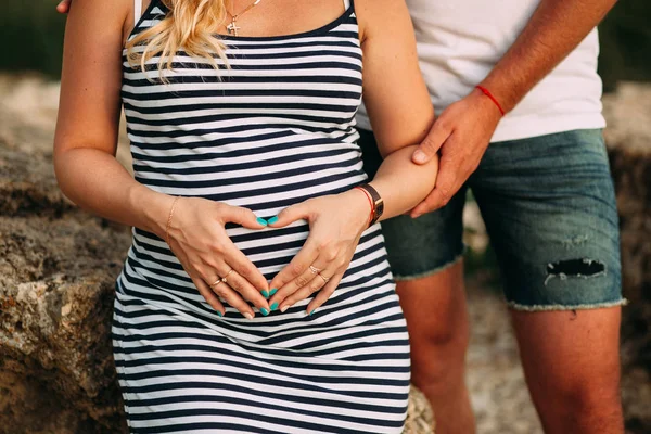 Pregnant Woman Striped Dress Makes Her Hands Her Belly Heart — Stock Photo, Image