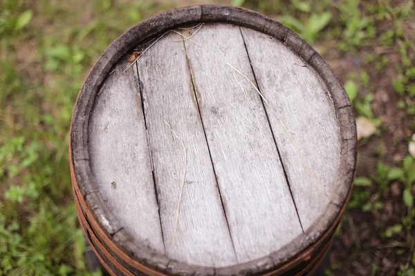 Rusty old barrel in the backyard of a rural house