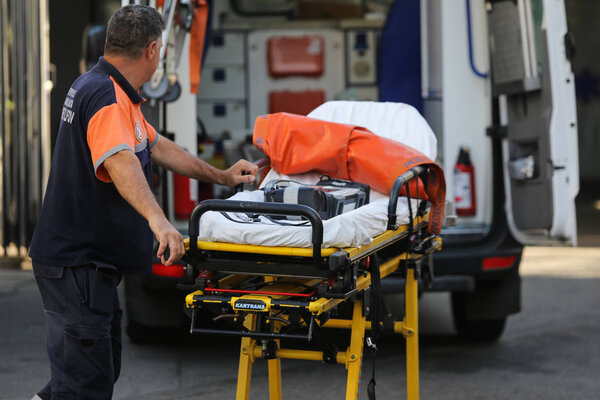 BUCHAREST, ROMANIA - August 13, 2018: Paramedic from an ambulance push an empty stretcher