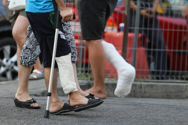 Details of the leg in a plaster cast of a patient going to the hospital with the help of a metal frame