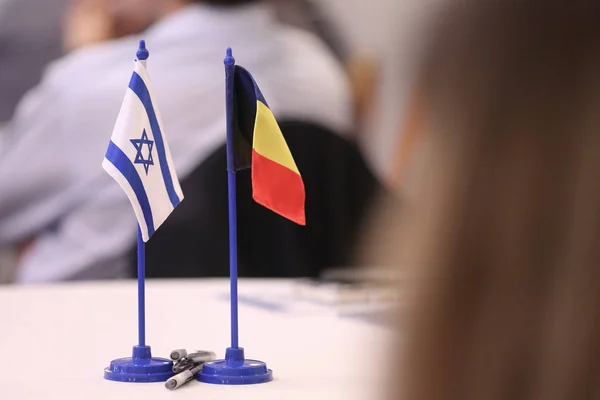 Romania and Israel flags one next to the other on a table. Israe