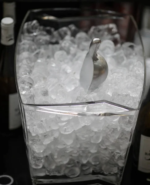 Details with an ice box and a shovel behind a bar counter.