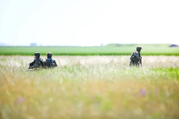 Soldats de l'armée roumaine restent dans un champ, par une journée d'été ensoleillée — Photo