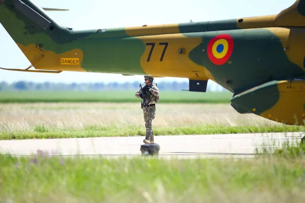 Un soldat de l'armée roumaine patrouille une base aérienne militaire, près d'une milita — Photo