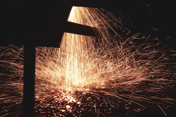 Sparks from a metal cutting machine in a dirty and old but still — Stock Photo, Image