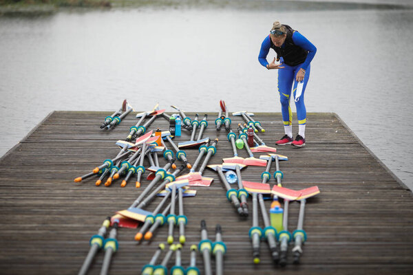Snagov, Romania - April 18, 2020: Romanian professional women rowers from the Olympic Team train in a sports base.