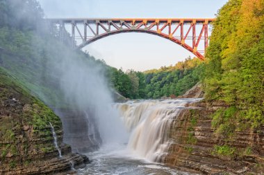 Upper Falls Arched Bridge At Letchworth State Park New York Just After Sunrise clipart