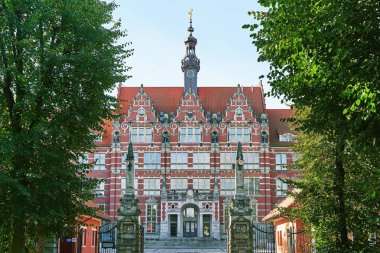 The main building of Gdansk University of Technology or Politechnika Gdanska with emblem above entrance in Poland clipart