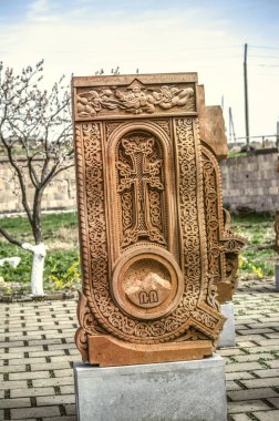 Stone cross carved with ornaments in the form of the first letter of the Armenian alphabet, created by Mesrop Mashtots in the village of Oshakan clipart