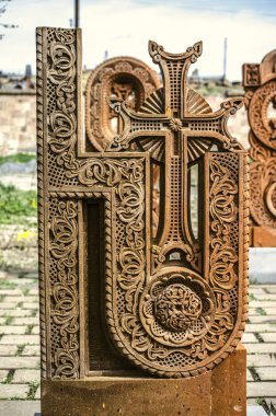  Stone cross carved with ornaments in the form of the thirteenth letter  of the Armenian alphabet, created by Mesrop Mashtots in the village of Oshakan clipart