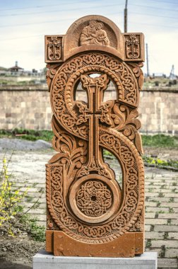 Stone cross carved with ornaments in the form of the thirty-first  letter  of the Armenian alphabet, created by Mesrop Mashtots in the village of Oshakan clipart