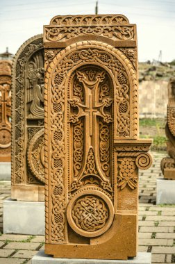  Stone cross carved with ornaments in the form of the thirty-second  letter  of the Armenian alphabet, created by Mesrop Mashtots in the village of Oshakan clipart