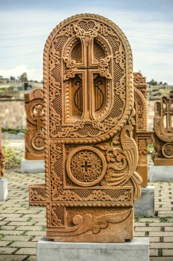 Stone cross carved with ornaments in the form of the thirty-sixth  letter  of the Armenian alphabet, created by Mesrop Mashtots in the village of Oshakan clipart