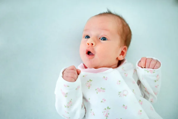 Cute two week old baby girl in cradle — Stock Photo, Image