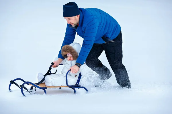 Adorable baby girl enjoying sledding. Father sledding his little daughter — Stock Photo, Image