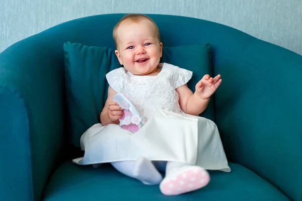 Portrait of happy little child wearing white dress in casual clothes posing indoors — Stock Photo, Image