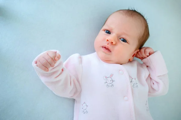 Emotional baby lying in cradle at home — Stock Photo, Image