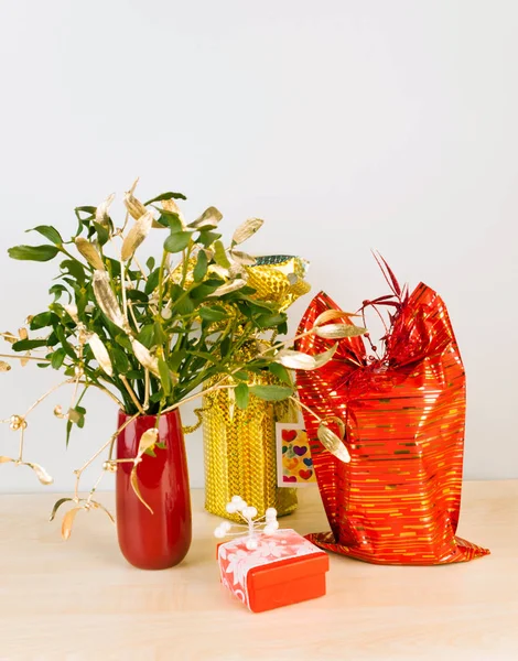 Gifts in red and silver package with mistletoe