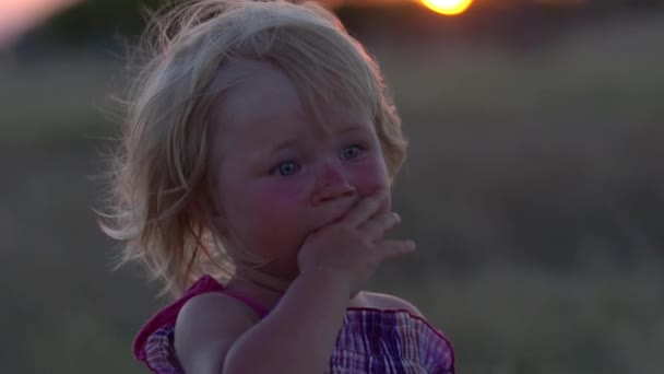 Closeup portrait of a little girl looking into the sky. Slow motion. — Stock Video