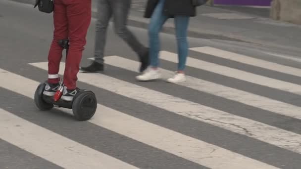 Facet jeździ na chodniku, stojąc na Hoverboard. Spacer na hoverboard. — Wideo stockowe