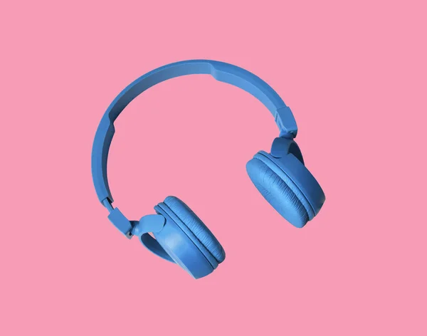 ヘッドフォン ピンクの背景に音楽の音のためのヘッドフォン ピンクの背景に隔離されています ピンクの背景に青いヘッドフォン 音楽の概念 — ストック写真