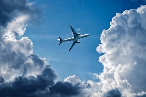 Complex flight conditions - plane flies through storm clouds, rainy weather, storm front.  Concept of air safety. Empty place for copy space.