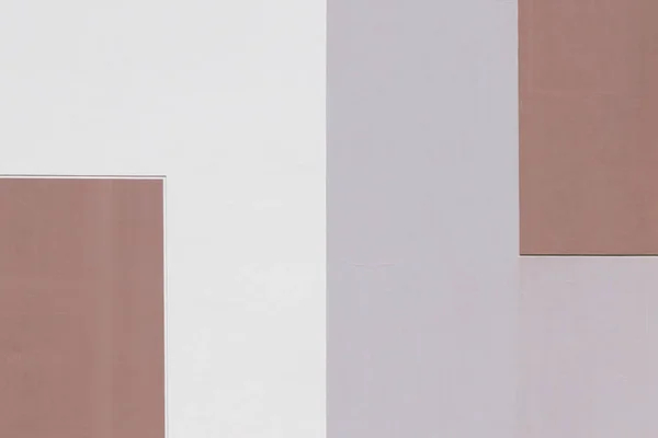 Abstract geometric background of pastel tones, divided into two parts, three-color rectangular painted texture, building wall with Indian Red, LightGray, gray colors. Empty place for copy space.