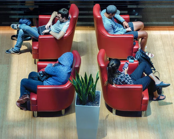 Top view of separate people, everyone does not pay attention to each other. Isolation, alienation, Introvert. Airport waiting room with armchairs. Together but apart.Ignore everything in word around.