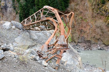 Doğal afet dağların, kıvılcımlarla etkileri, doğanın, elektrik direği, daraltılmış bir dağ yamacı üzerinden nehre demir ayağı çöktü. Georgia, Svaneti