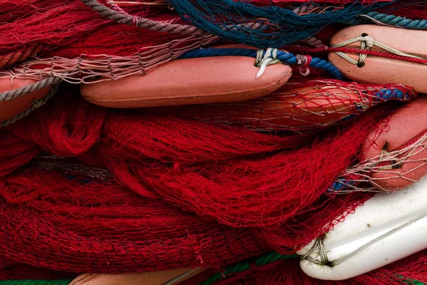 Fishing nets with floats. Rope texture, Background with blue and red netting