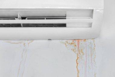 Wall with mold stain due to air conditioner leakage, close up. clipart