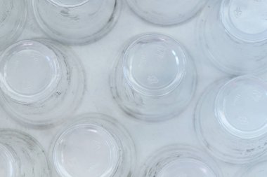 Dirty empty plastic glasses on a white background, top view. clipart