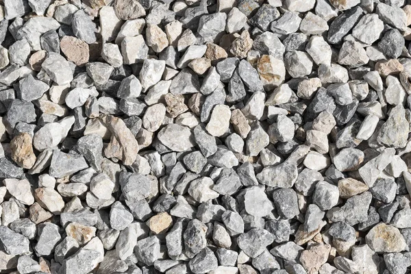 Malé kameny šedo bílé pozadí. Přírodní prostředí materiál — Stock fotografie